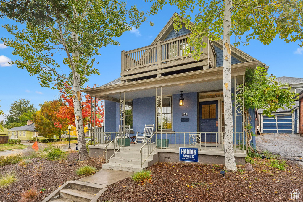 View of front facade featuring covered porch and a garage