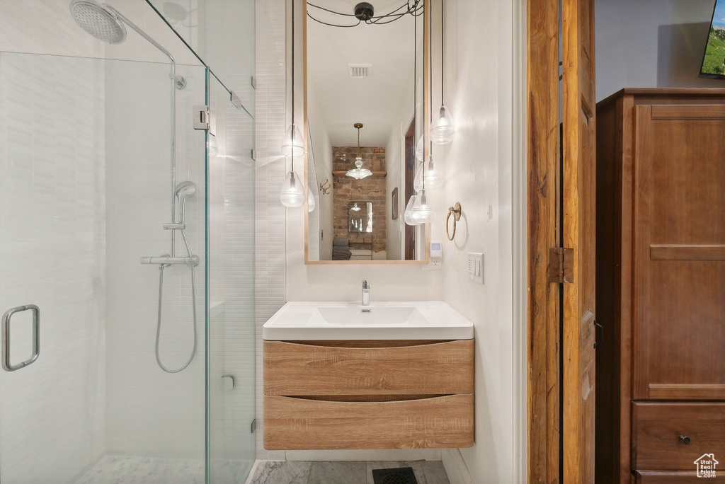 Bathroom with a shower stall and vanity