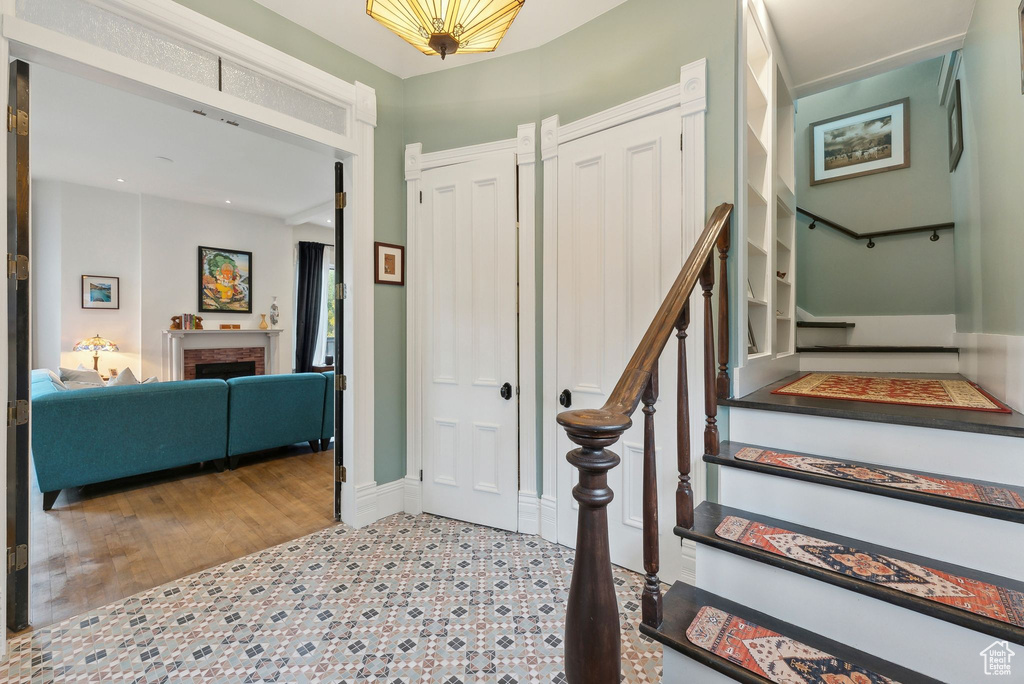 Entryway with stairway and a fireplace