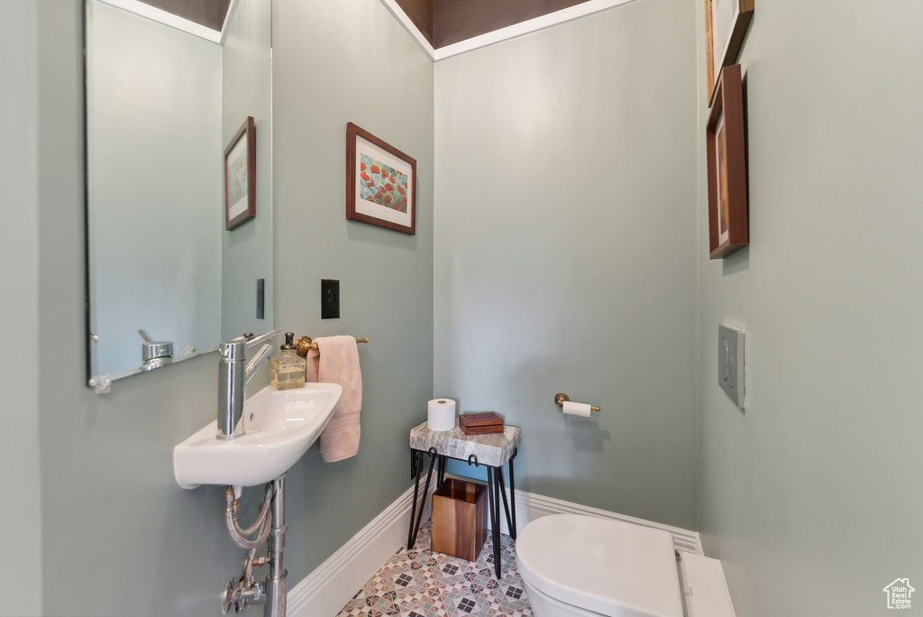 Bathroom with toilet and baseboards
