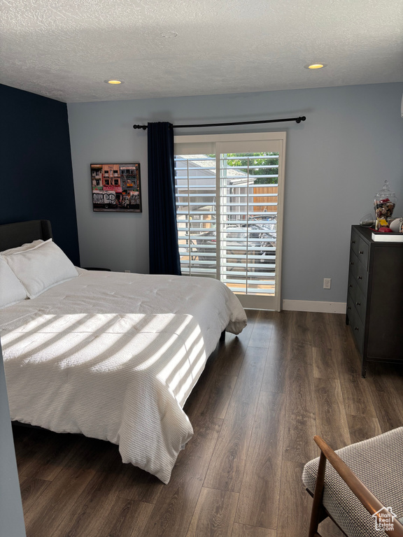 Bedroom featuring a textured ceiling, wood finished floors, and recessed lighting