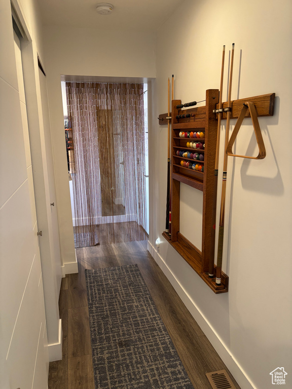 Corridor featuring wood finished floors and baseboards