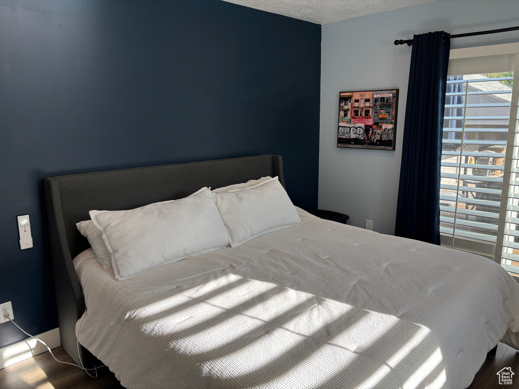 Bedroom featuring wood finished floors and a textured ceiling