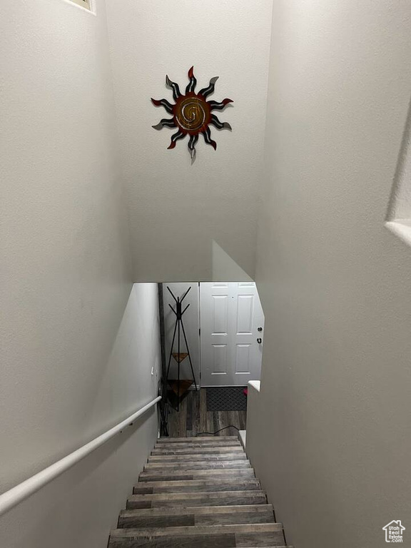 Staircase featuring wood finished floors