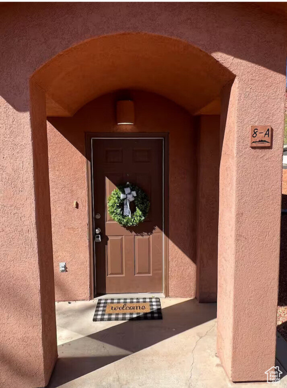 Property entrance featuring stucco siding