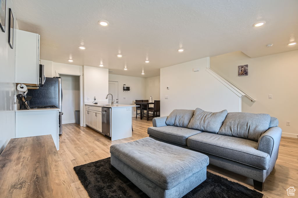 Living room featuring light wood-style floors and recessed lighting