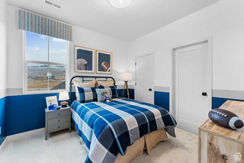 Carpeted bedroom featuring baseboards