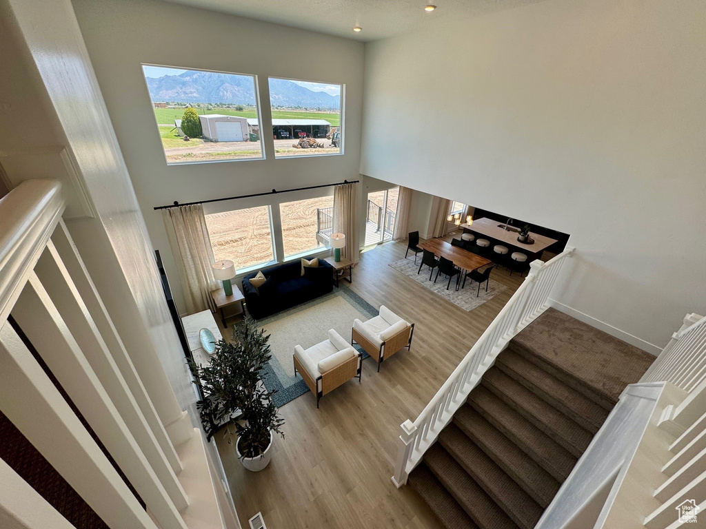 Living room with a towering ceiling and wood finished floors
