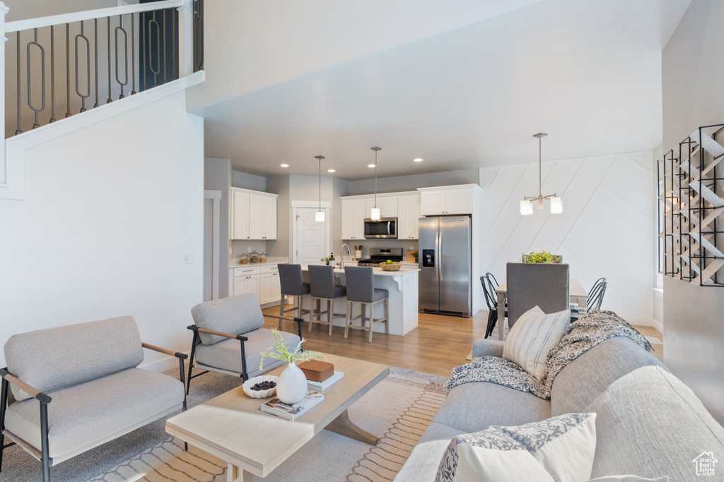 Living area featuring stairs, light wood finished floors, and recessed lighting