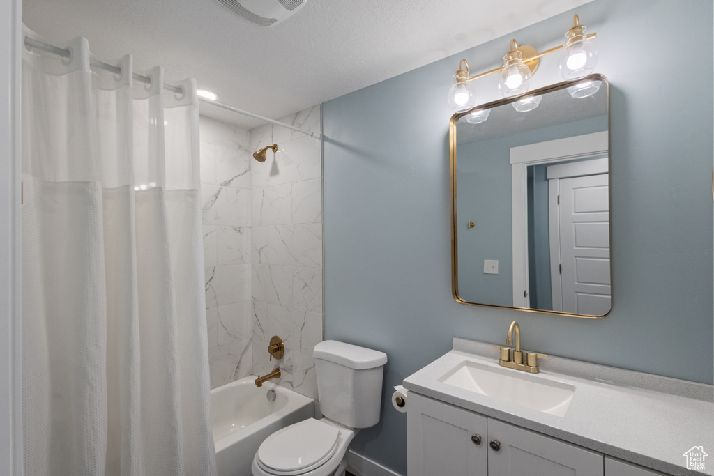 Bathroom featuring vanity and shower / tub combo