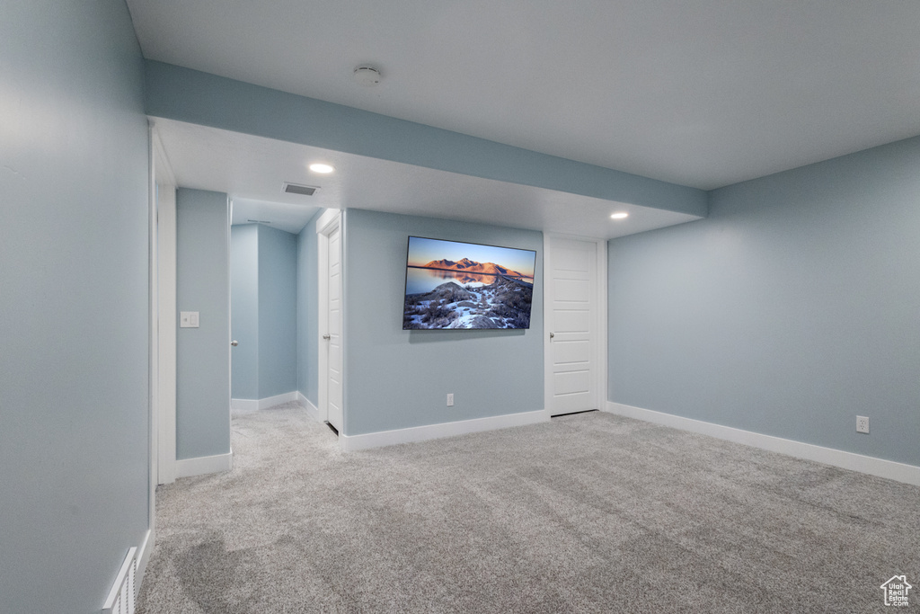 Finished below grade area featuring carpet floors and recessed lighting