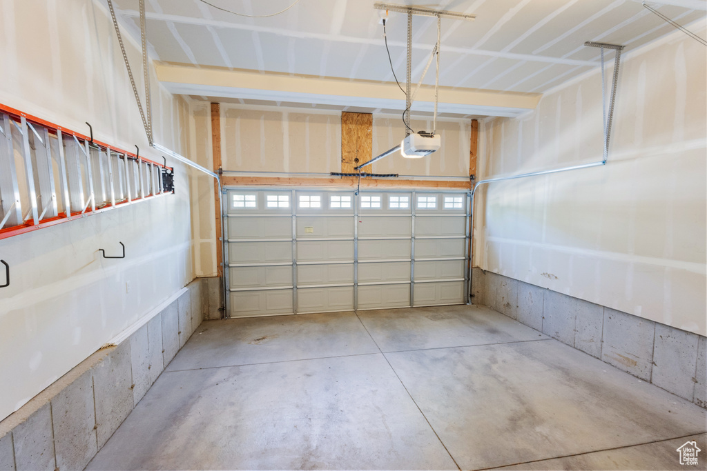Garage featuring a garage door opener