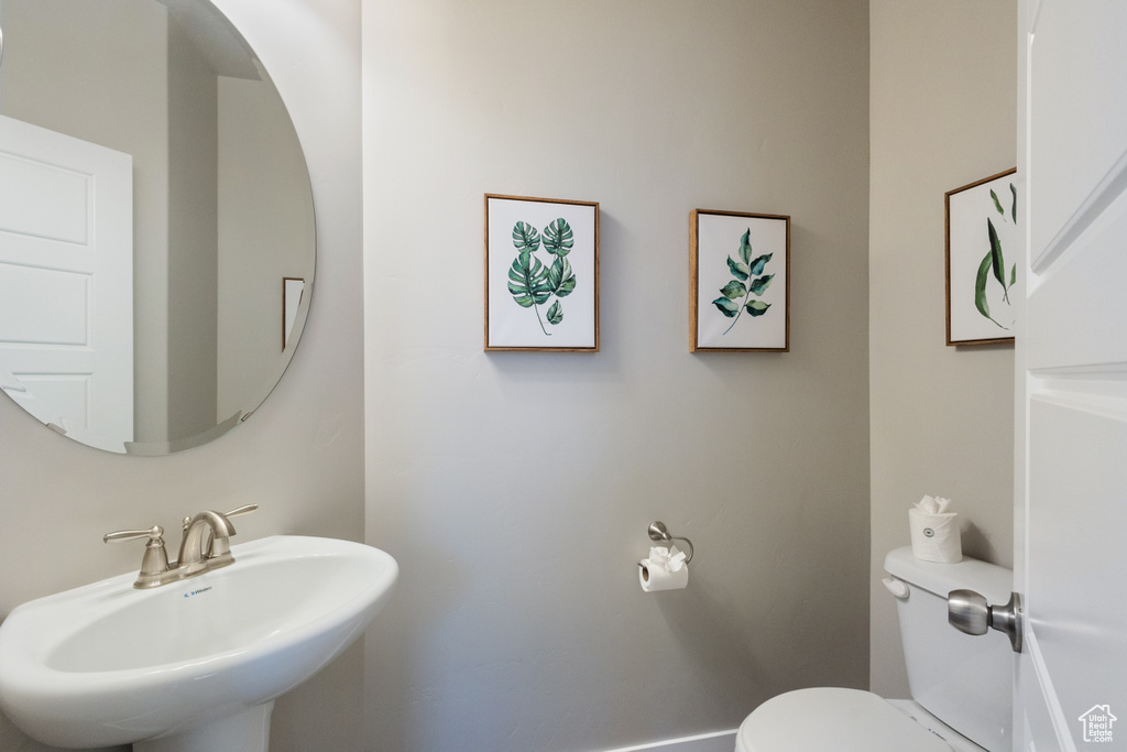Half bath with a sink and toilet