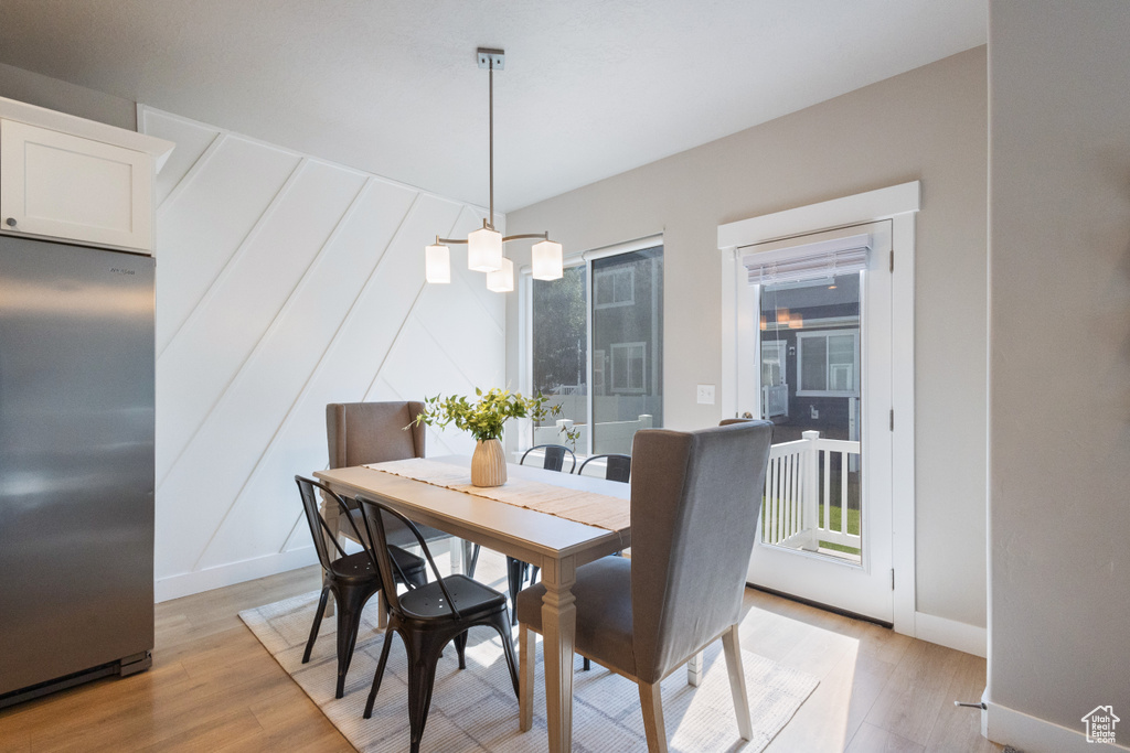 Dining area with light wood finished floors and healthy amount of natural light
