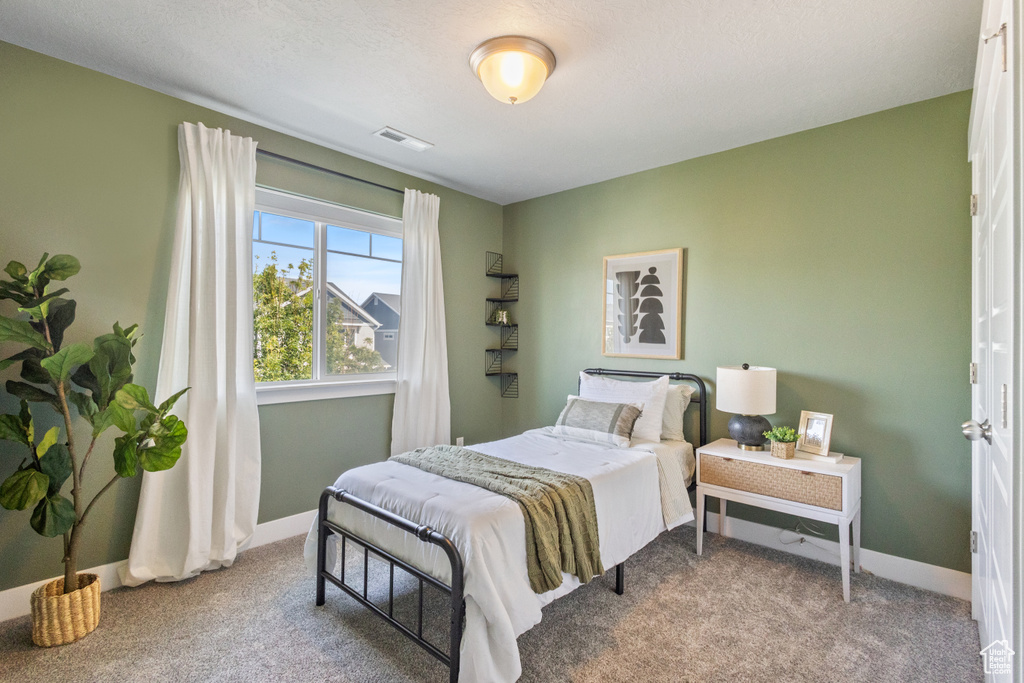 Carpeted bedroom featuring baseboards