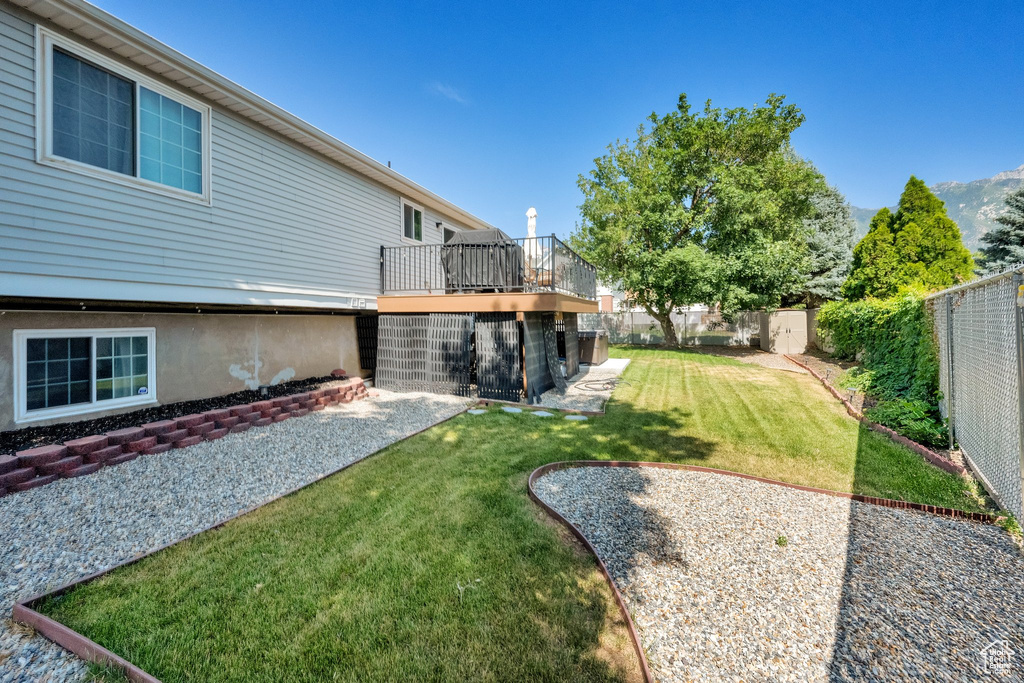 Fenced backyard with a deck and a patio