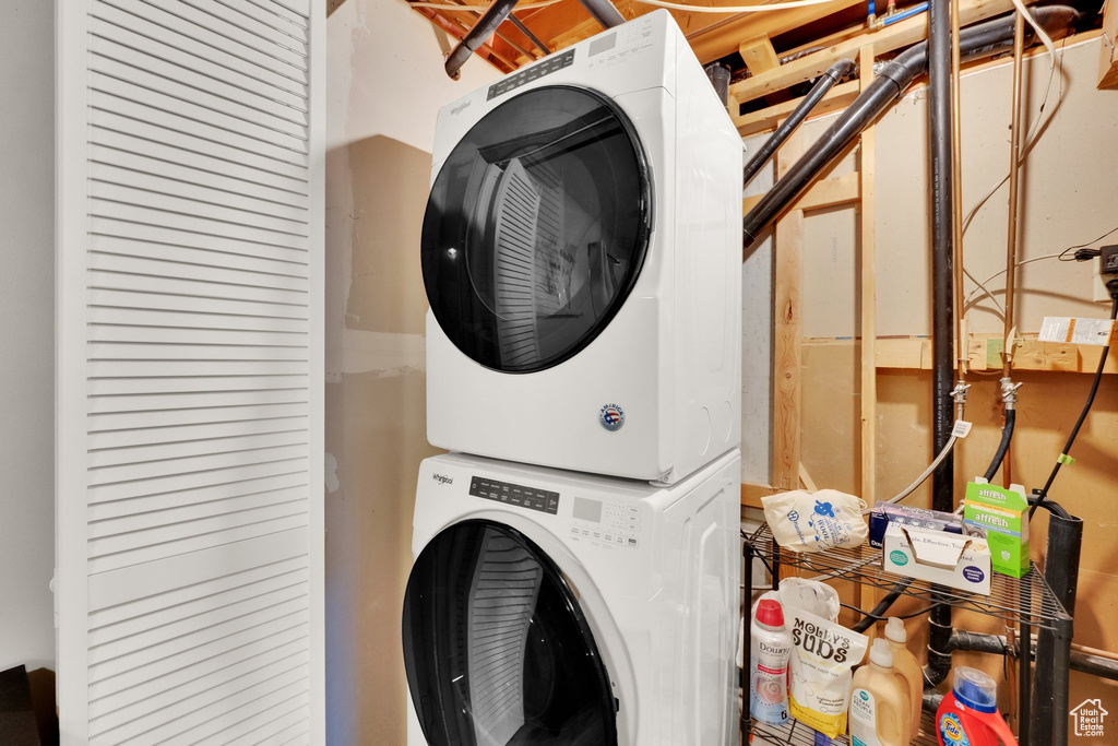 Washroom featuring stacked washer and clothes dryer