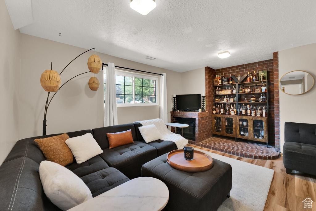 Living room featuring wood finished floors and a textured ceiling