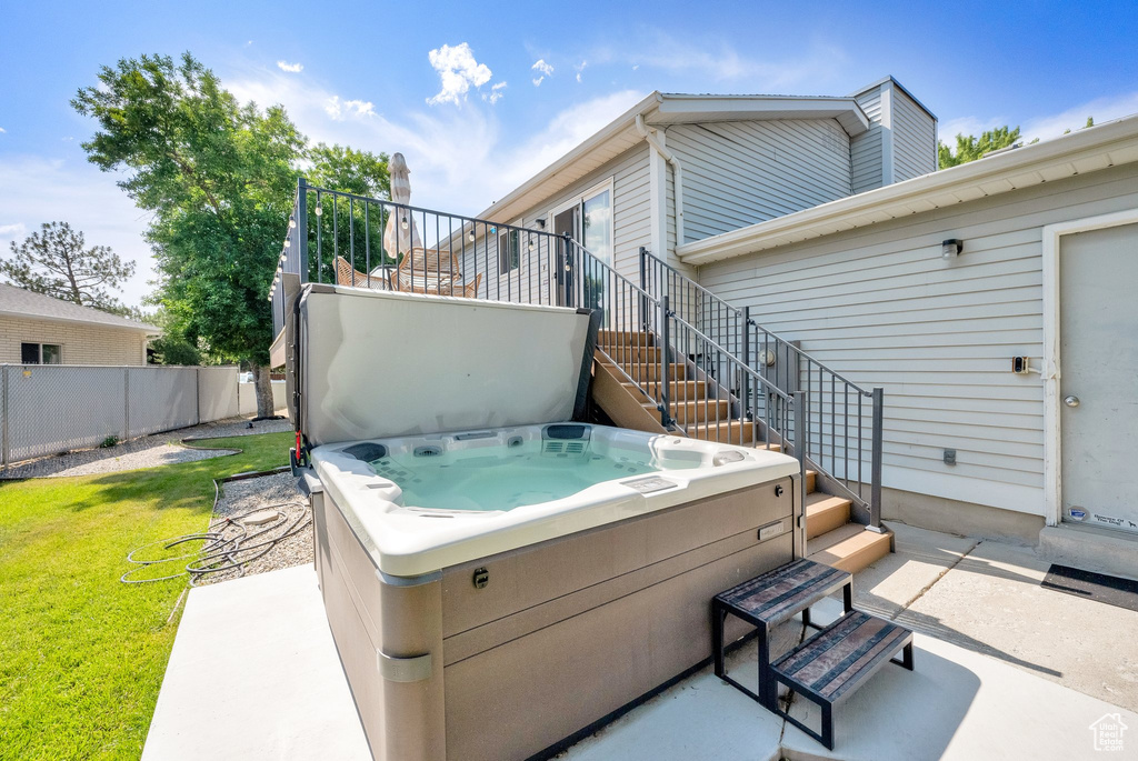 View of patio featuring a hot tub and stairs