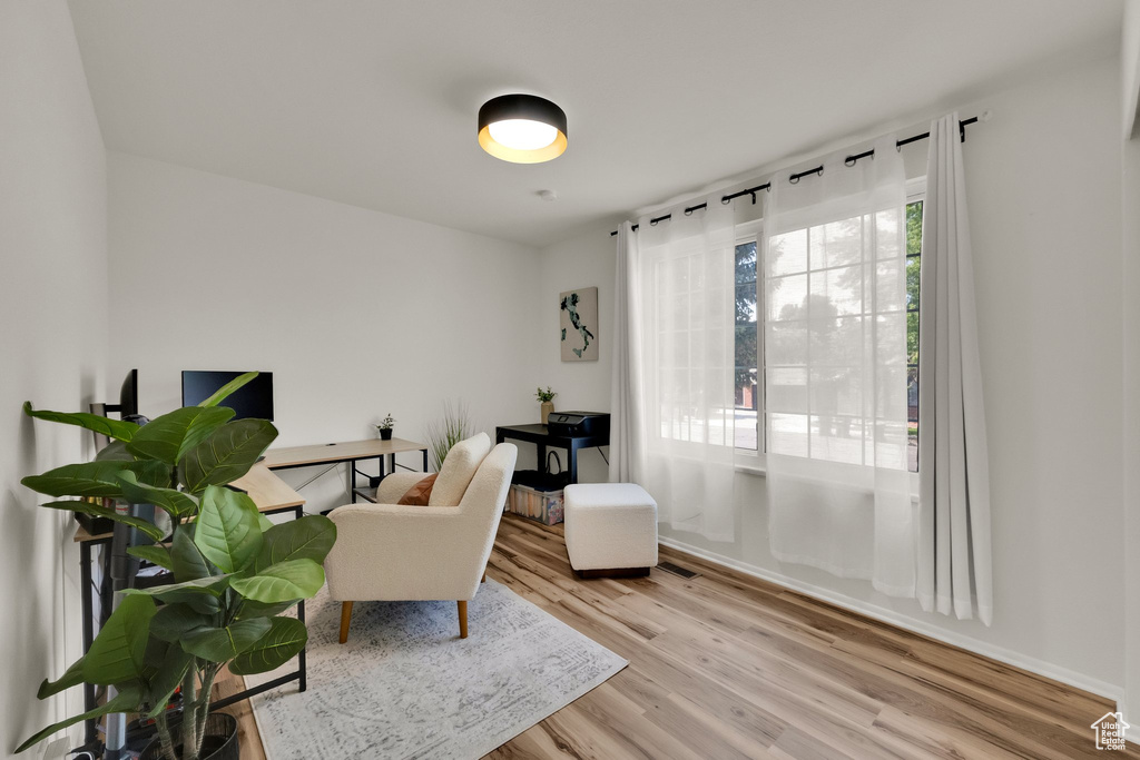 Office area featuring light wood-style floors
