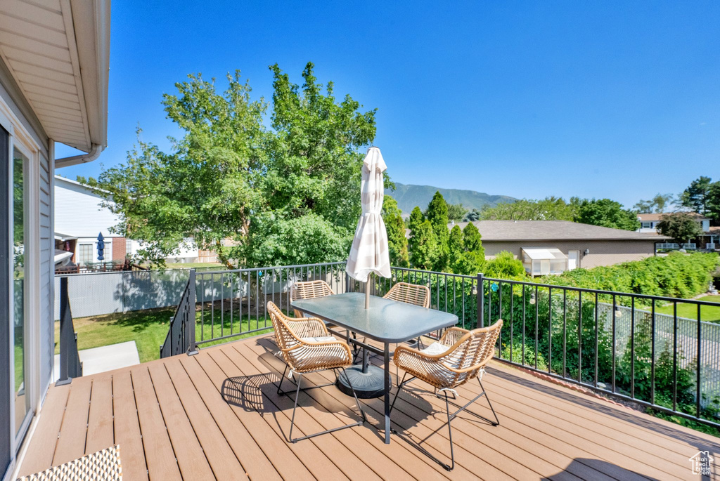 Wooden terrace with a mountain view and outdoor dining space