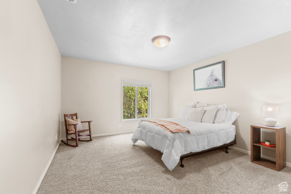 Carpeted bedroom with baseboards