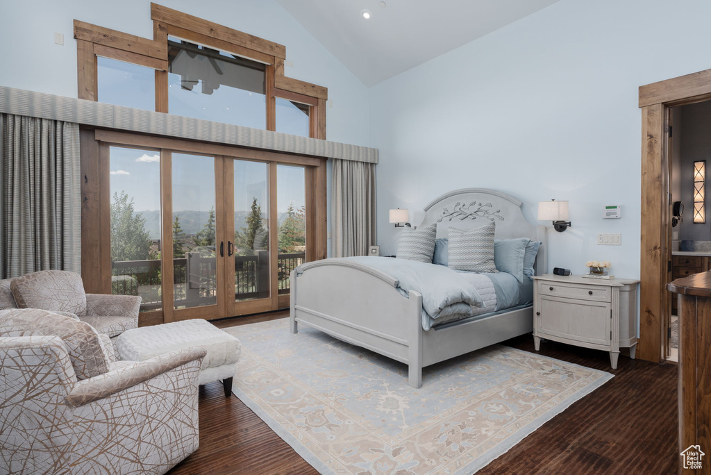Bedroom featuring access to exterior, french doors, high vaulted ceiling, dark wood-style flooring, and recessed lighting