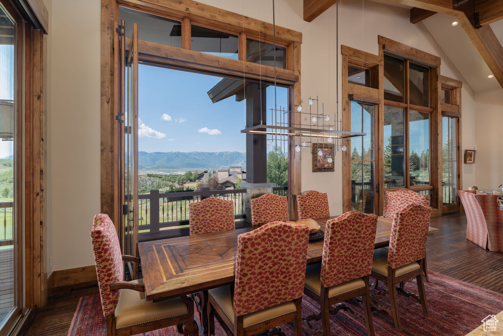 Dining space with wood finished floors, beamed ceiling, a mountain view, recessed lighting, and high vaulted ceiling