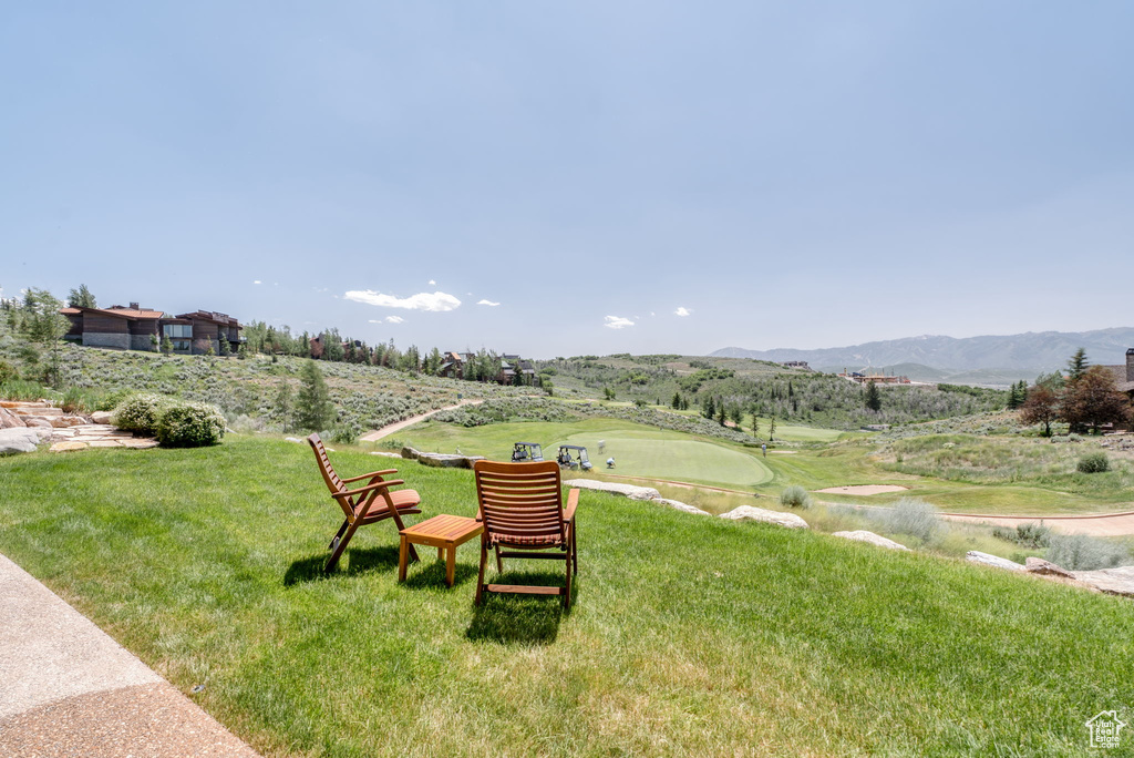 View of grassy yard with a mountain view