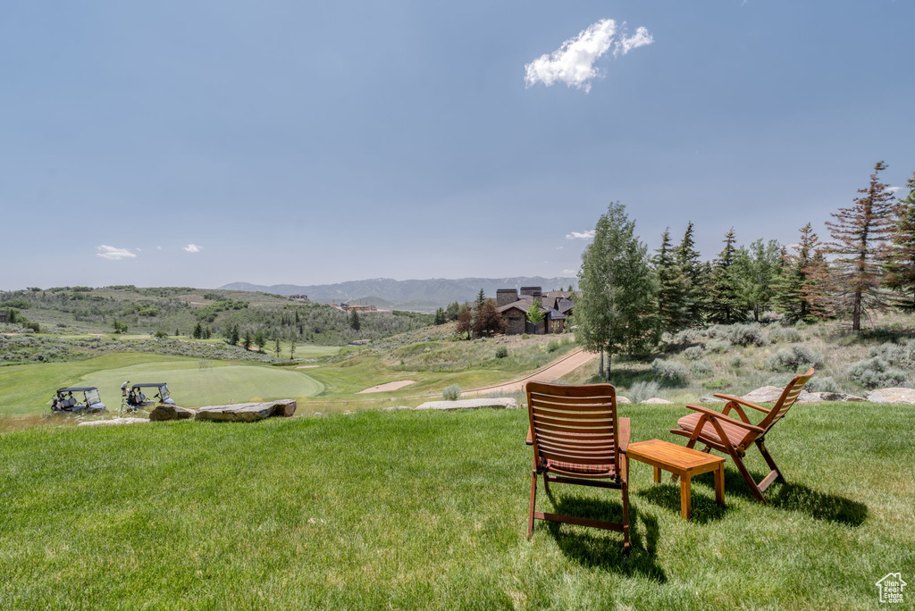 View of green lawn featuring a mountain view