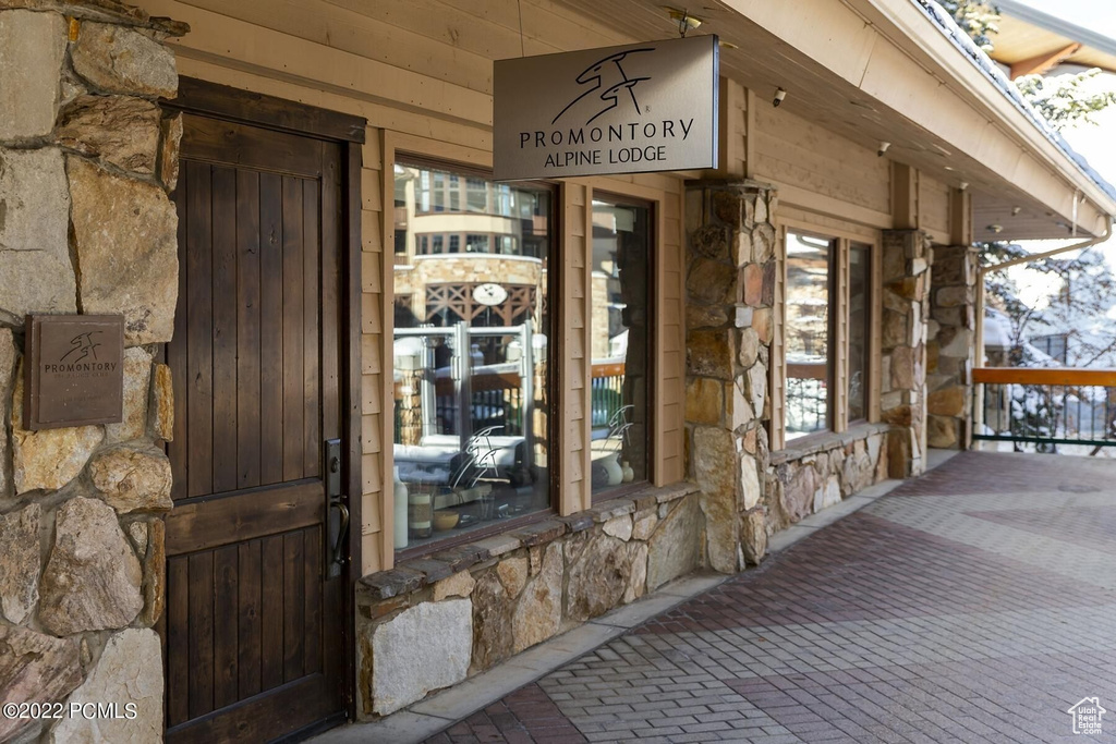 Property entrance featuring stone siding and a porch