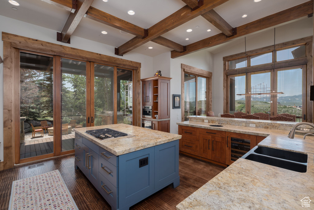Kitchen with wine cooler, beam ceiling, coffered ceiling, dark wood-style floors, and stainless steel gas cooktop