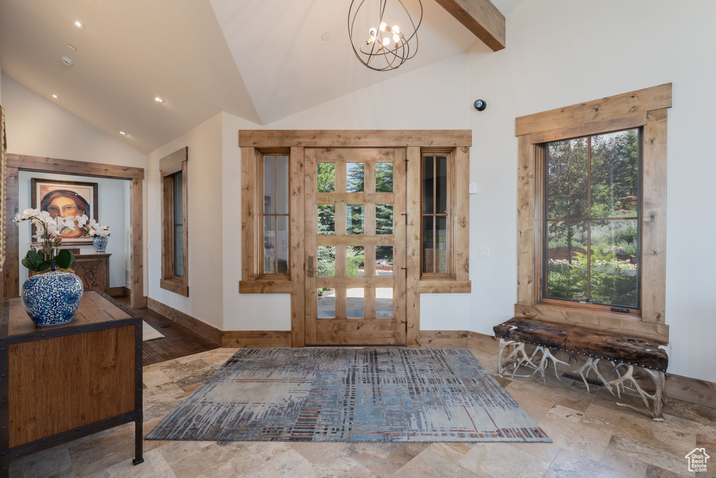 Entryway with a chandelier, stone tile floors, high vaulted ceiling, recessed lighting, and beamed ceiling