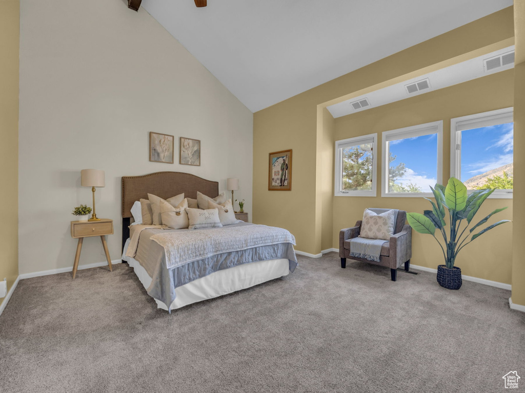 Bedroom with carpet, high vaulted ceiling, and a ceiling fan