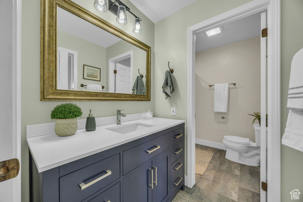 Bathroom featuring vanity and toilet