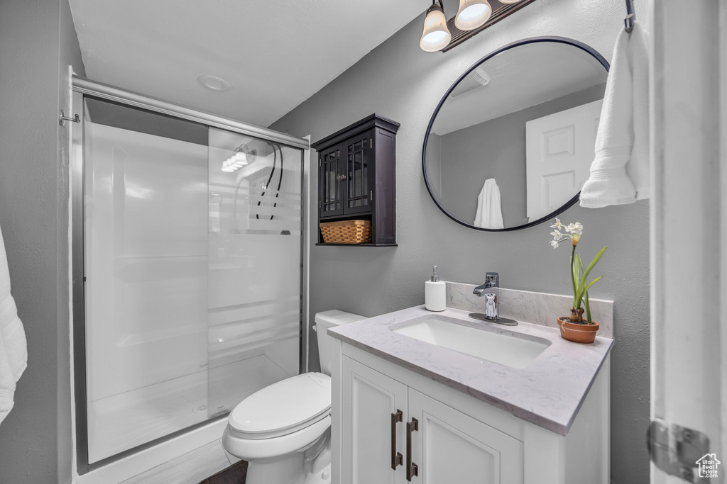 Full bath with a stall shower and vanity