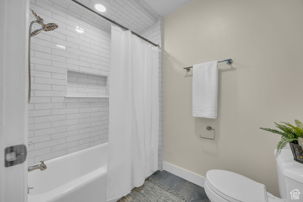 Full bathroom featuring toilet and shower / bath combo