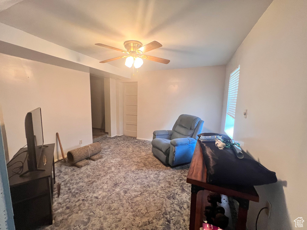 Sitting room featuring carpet and ceiling fan