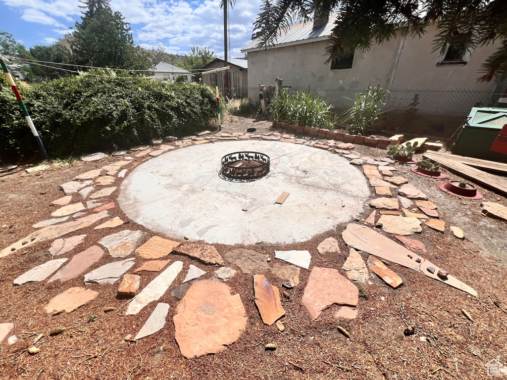 View of patio with a fire pit