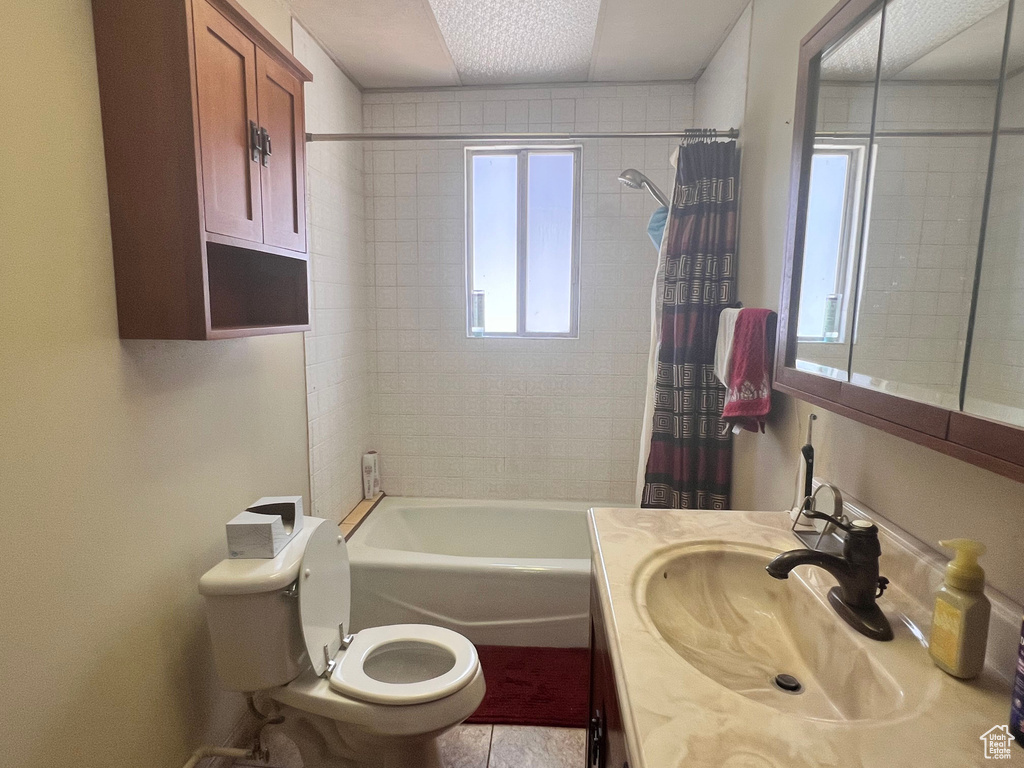 Full bathroom featuring vanity, shower / bath combo, and tile patterned floors