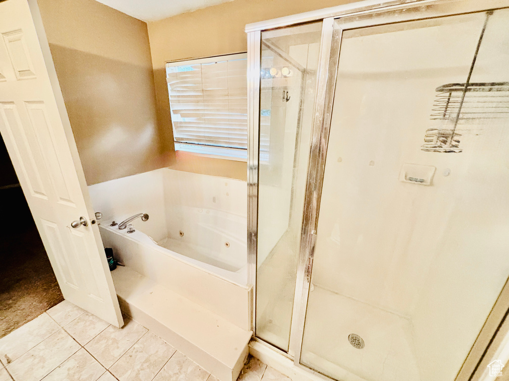 Full bathroom with a tub with jets, a stall shower, and tile patterned flooring