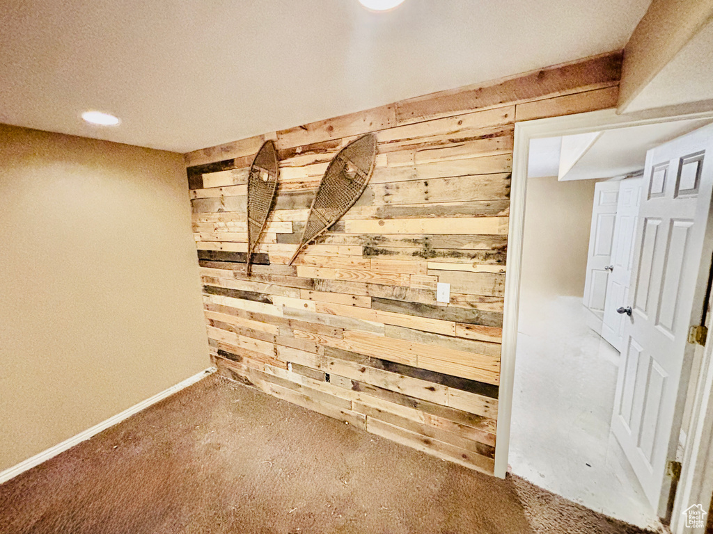 Finished below grade area with wood walls and carpet