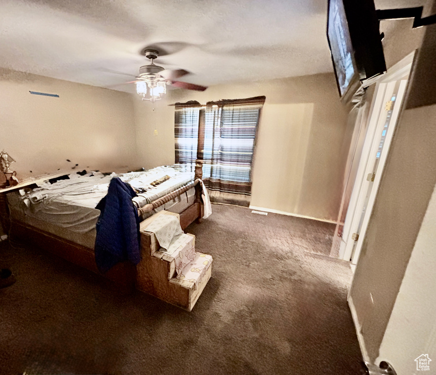 Bedroom with carpet and a ceiling fan