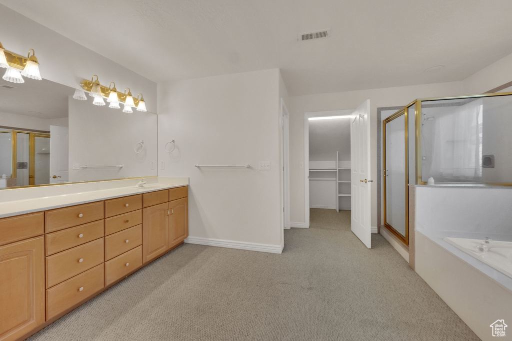 Full bathroom with carpet flooring, a stall shower, double vanity, and a bath