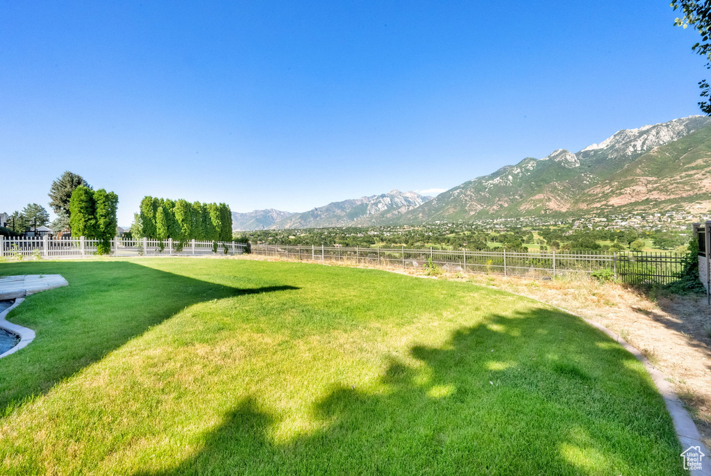 Fenced backyard with a mountain view