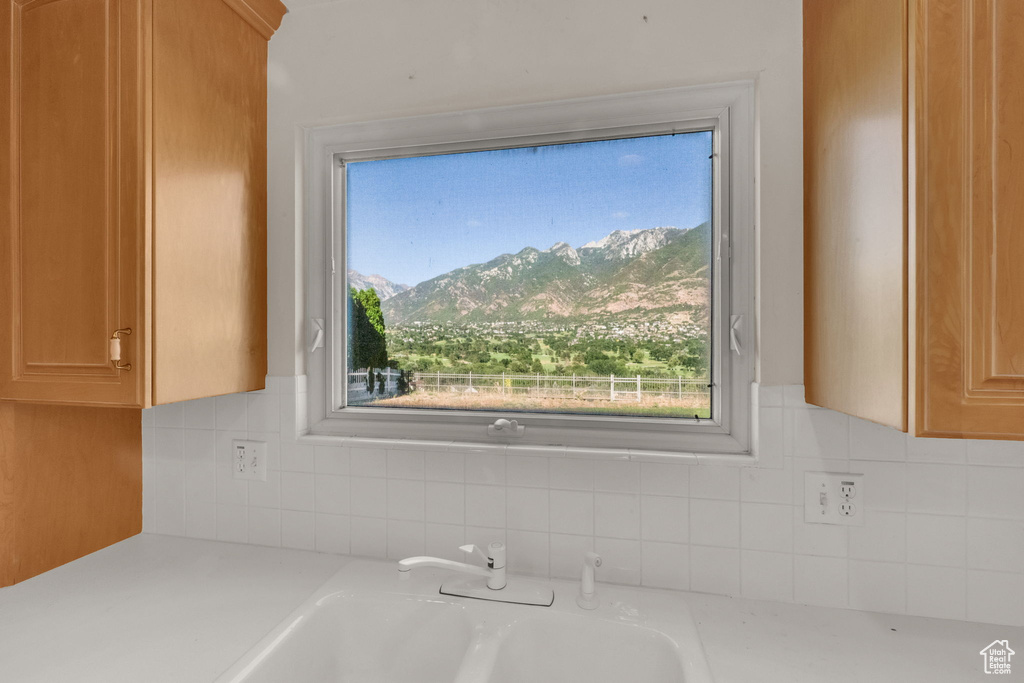 Kitchen view of light countertops and backsplash