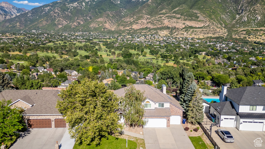 Aerial view of residential area featuring a mountainous background