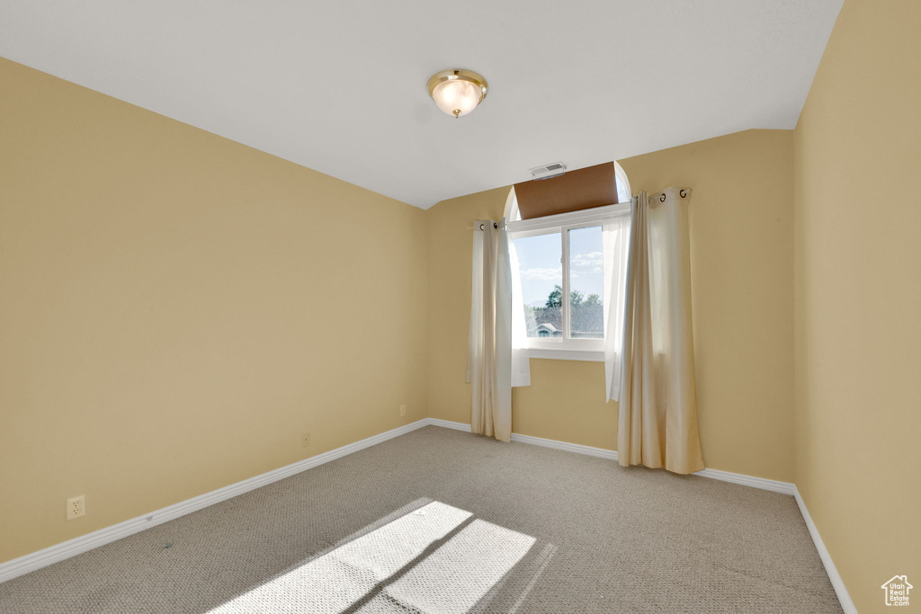 Unfurnished room featuring carpet and baseboards