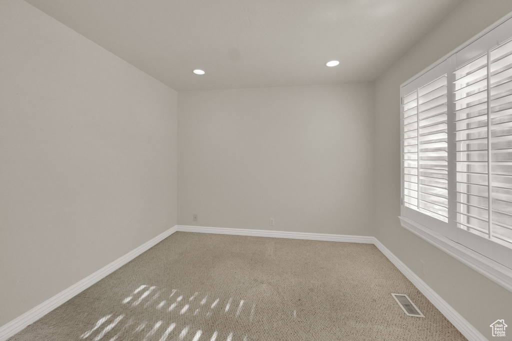 Spare room featuring carpet floors and recessed lighting
