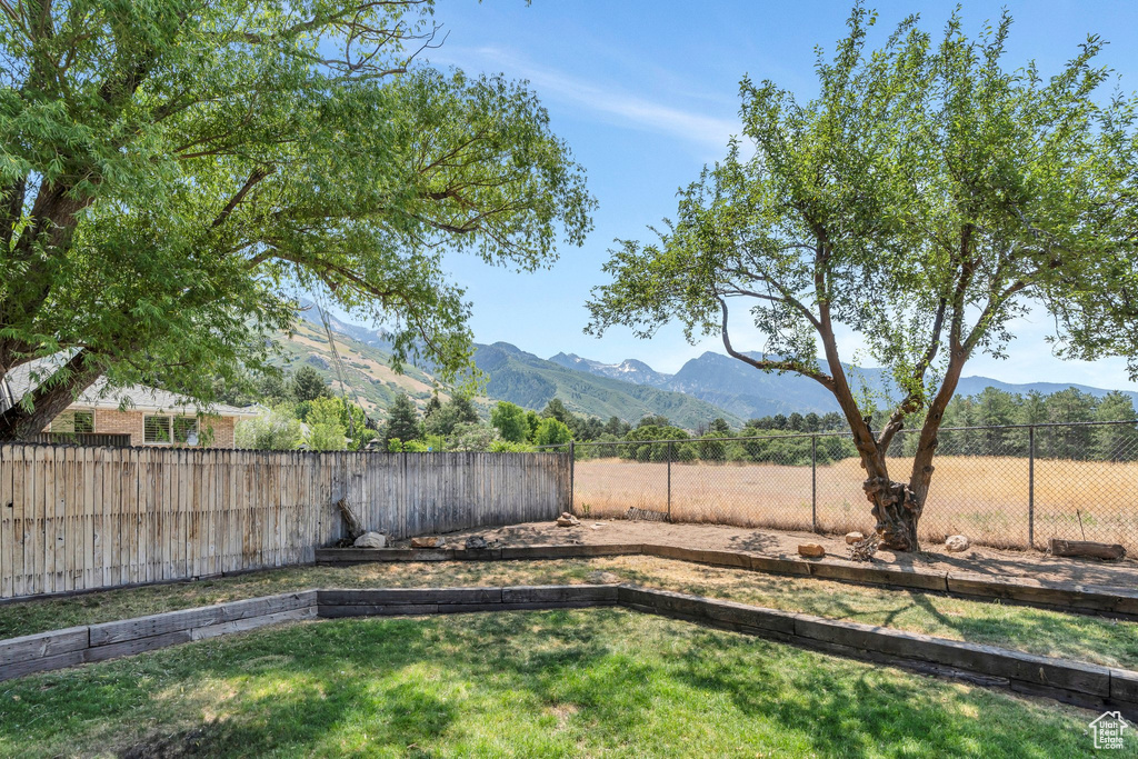 Fenced backyard with a mountain view